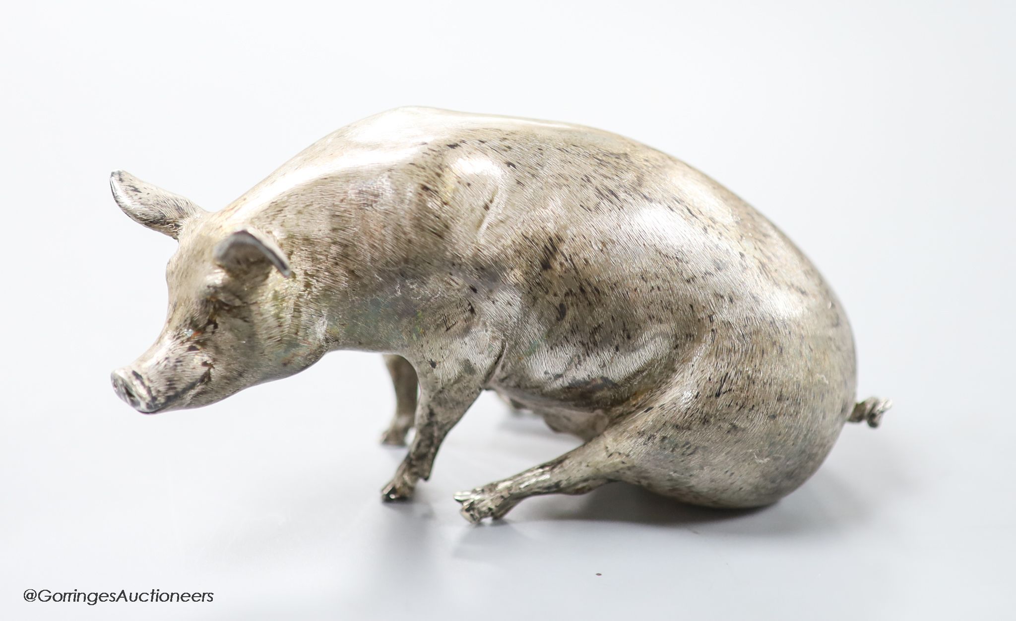 A modern silver miniature model of a seated pig, C.F.H & Co, London, 1993, height 65mm, 302 grams.